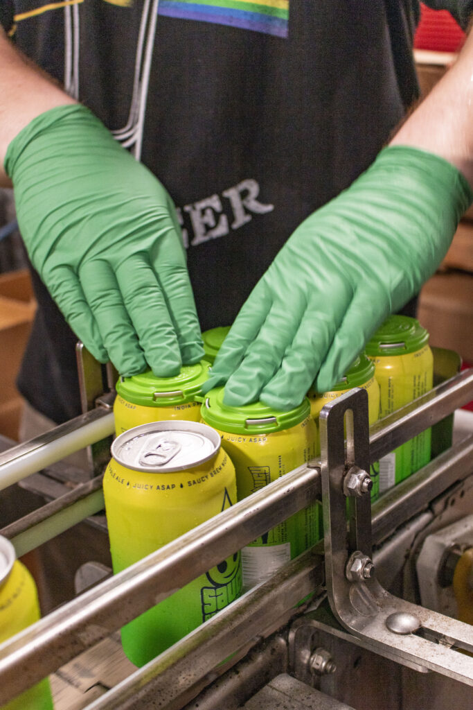 Brewer packaging Juicy Asap cans.