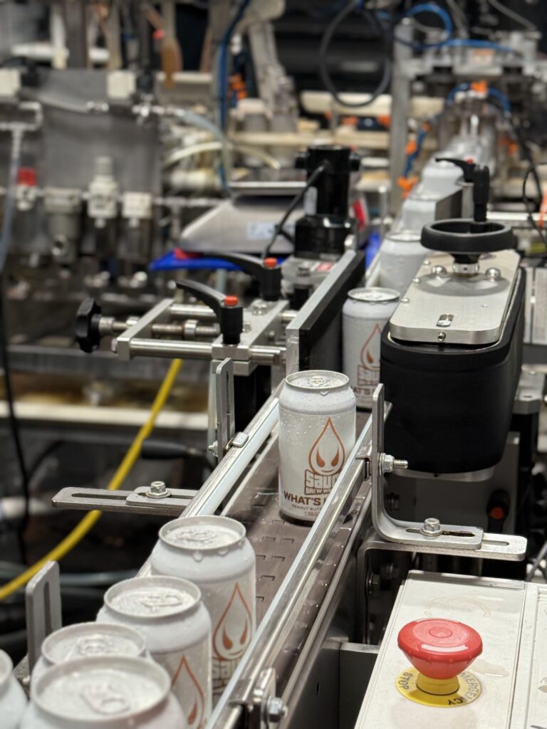 Cans of What's His Nuts coming down the canning line.